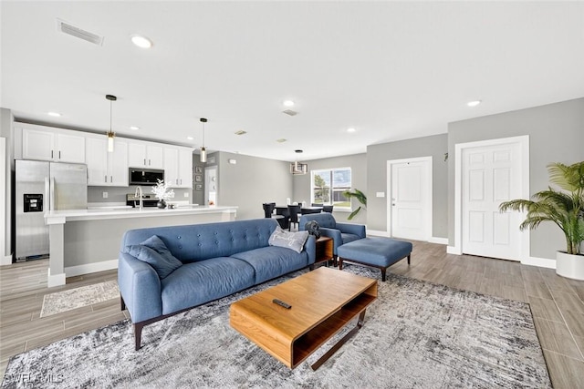 2008 NW 24th Pl, Cape Coral, FL 33993 - living area featuring light wood-style flooring and recessed lighting