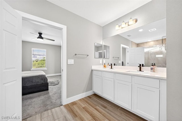 2008 NW 24th Pl, Cape Coral, FL 33993 - bathroom with double vanity, a tile shower, wood finish floors, a ceiling fan, and ensuite bathroom