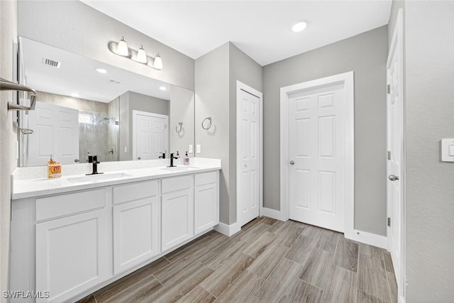 2008 NW 24th Pl, Cape Coral, FL 33993 - full bathroom featuring a stall shower, double vanity, and wood finished floors