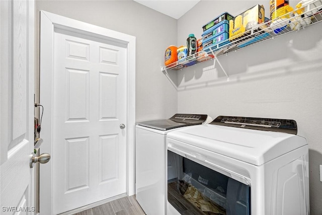 2008 NW 24th Pl, Cape Coral, FL 33993 - laundry room featuring washing machine and clothes dryer and light wood finished floors