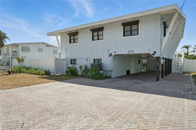 370 Bayland Rd, Fort Myers Beach, FL 33931 - view of front of house featuring a carport and decorative driveway