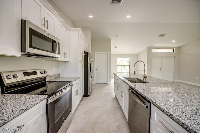 4114 2nd St SW, Lehigh Acres, FL 33976 - kitchen featuring appliances with stainless steel finishes, white cabinetry, light stone countertops, finished concrete flooring, and recessed lighting