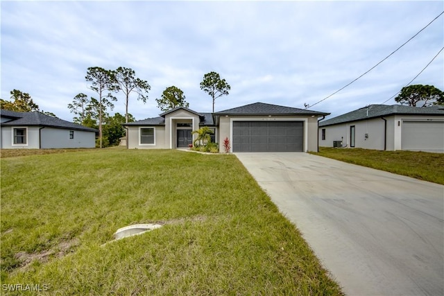 4114 2nd St SW, Lehigh Acres, FL 33976 - view of front of house with concrete driveway, a front yard, a garage, and stucco siding