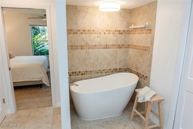 3430 27th Ave SW, Naples, FL 34117 - ensuite bathroom featuring a freestanding bath, tile patterned flooring, and a ceiling fan
