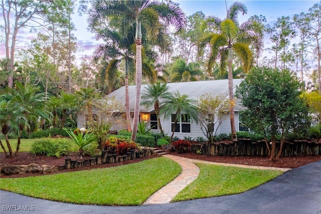 3430 27th Ave SW, Naples, FL 34117 - view of property hidden behind natural elements featuring a front lawn