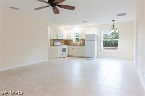 3430 27th Ave SW, Naples, FL 34117 - unfurnished living room featuring ceiling fan