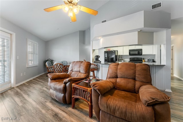 950 Moody Rd Unit 124, North Fort Myers, FL 33903 - living area with high vaulted ceiling, wood finished floors, a ceiling fan, and baseboards