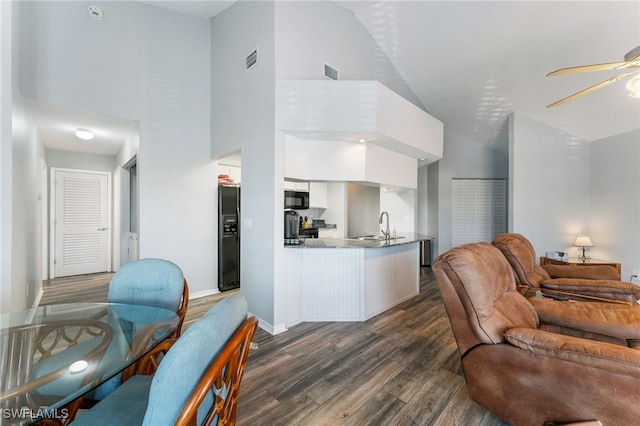 950 Moody Rd Unit 124, North Fort Myers, FL 33903 - living room with ceiling fan, high vaulted ceiling, dark wood-style flooring, and baseboards