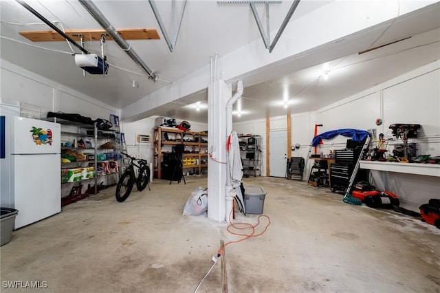 950 Moody Rd Unit 124, North Fort Myers, FL 33903 - garage with freestanding refrigerator, a workshop area, and a garage door opener