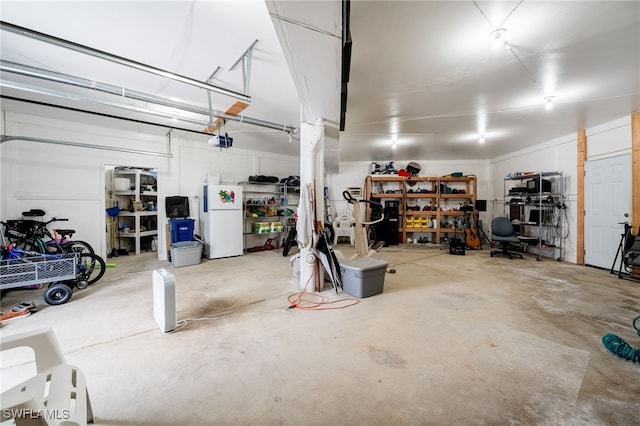 950 Moody Rd Unit 124, North Fort Myers, FL 33903 - garage featuring freestanding refrigerator and a garage door opener