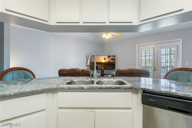 950 Moody Rd Unit 124, North Fort Myers, FL 33903 - kitchen featuring stainless steel dishwasher, open floor plan, white cabinetry, and ceiling fan