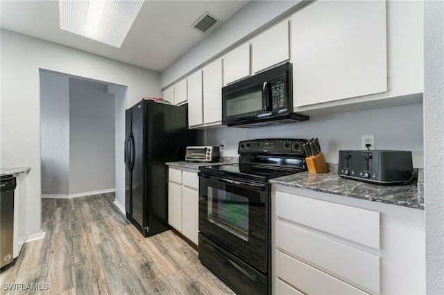 950 Moody Rd Unit 124, North Fort Myers, FL 33903 - kitchen featuring black appliances, white cabinetry, light wood finished floors, and baseboards