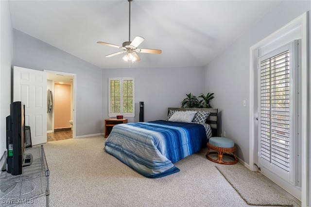 950 Moody Rd Unit 124, North Fort Myers, FL 33903 - carpeted bedroom featuring lofted ceiling, multiple windows, ceiling fan, and ensuite bath