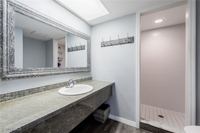 950 Moody Rd Unit 124, North Fort Myers, FL 33903 - full bathroom featuring wood finished floors, vanity, and tiled shower
