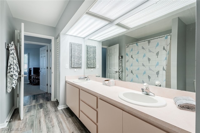 950 Moody Rd Unit 124, North Fort Myers, FL 33903 - bathroom with double vanity, wood finished floors, and curtained shower