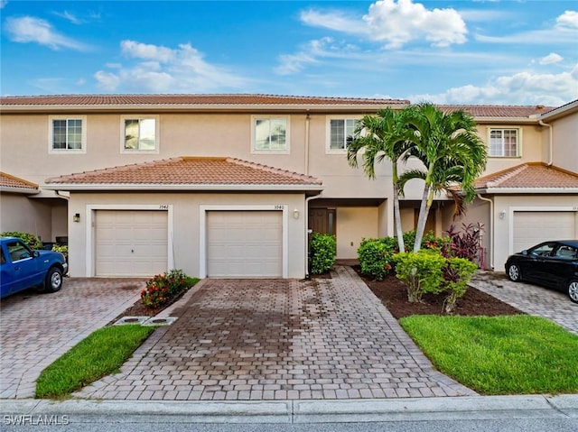 3940 Cherrybrook Loop, Fort Myers, FL 33966 - townhome / multi-family property with stucco siding, decorative driveway, and a tiled roof