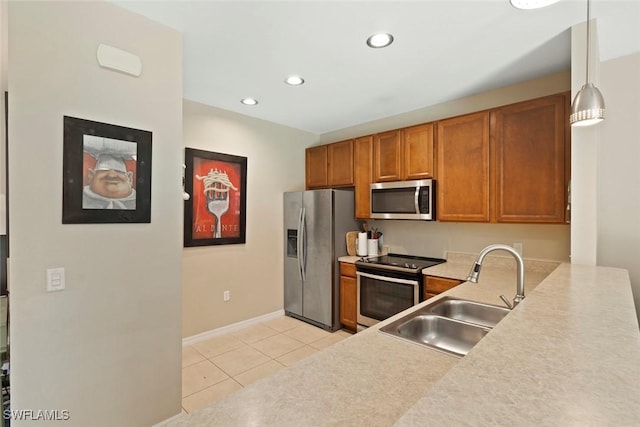 3940 Cherrybrook Loop, Fort Myers, FL 33966 - kitchen with appliances with stainless steel finishes, light tile patterned floors, brown cabinets, recessed lighting, and light countertops