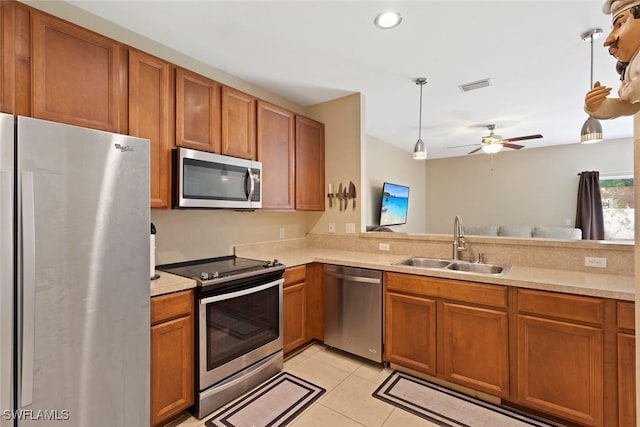 3940 Cherrybrook Loop, Fort Myers, FL 33966 - kitchen featuring stainless steel appliances, light countertops, and brown cabinets