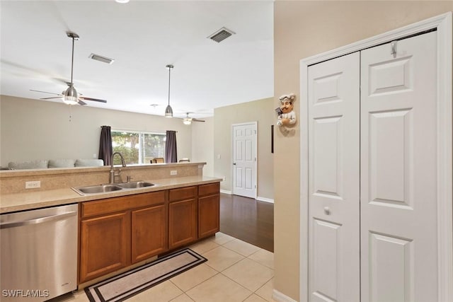 3940 Cherrybrook Loop, Fort Myers, FL 33966 - kitchen with stainless steel dishwasher, ceiling fan, brown cabinetry, and light tile patterned floors
