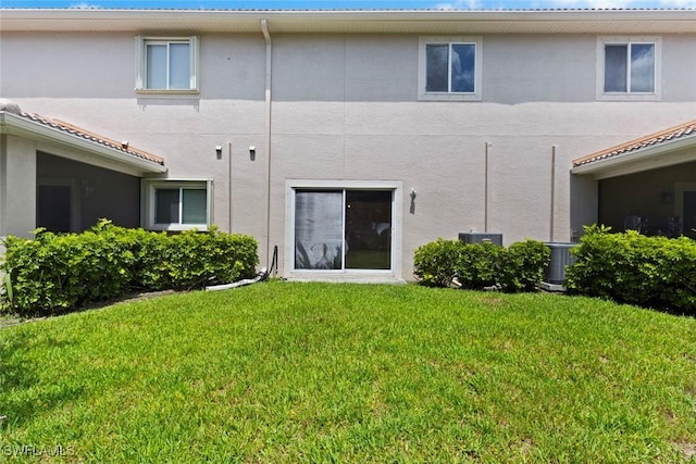 3940 Cherrybrook Loop, Fort Myers, FL 33966 - rear view of house with stucco siding and a yard