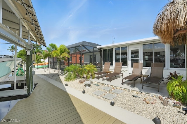 2749 Bruce St, Matlacha, FL 33993 - wooden deck with boat lift, a patio, a dock, and a lanai