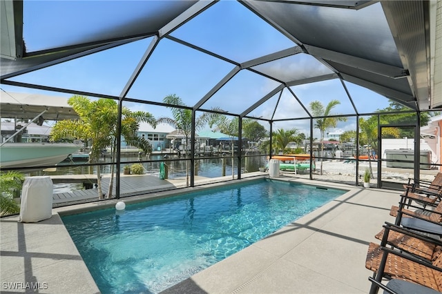 2749 Bruce St, Matlacha, FL 33993 - swimming pool featuring a water view, a dock, a patio area, boat lift, and glass enclosure