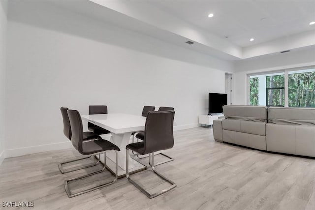 3320 41st Ave NE, Naples, FL 34120 - dining space with light wood-style floors, recessed lighting, and a tray ceiling
