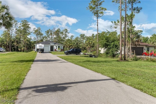 3320 41st Ave NE, Naples, FL 34120 - view of front of property featuring a front yard, driveway, and an attached garage