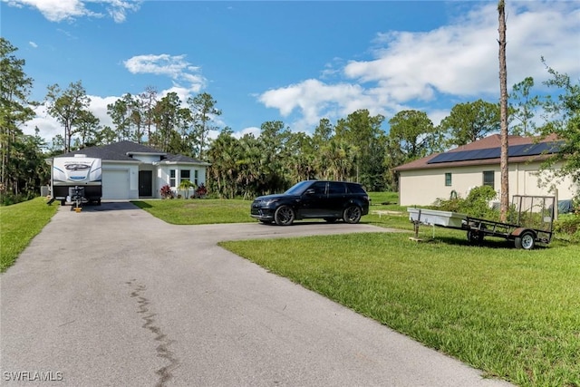 3320 41st Ave NE, Naples, FL 34120 - view of grassy yard featuring driveway and an attached garage
