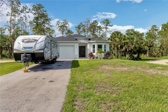 3320 41st Ave NE, Naples, FL 34120 - view of front of home with asphalt driveway, a front yard, an attached garage, and stucco siding
