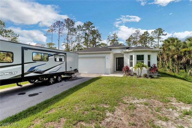 3320 41st Ave NE, Naples, FL 34120 - view of front facade with stucco siding, a front yard, driveway, and an attached garage
