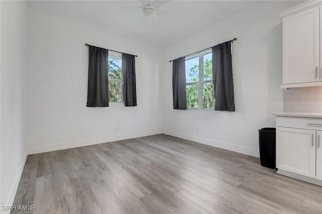 3320 41st Ave NE, Naples, FL 34120 - spare room with light wood-style flooring and baseboards