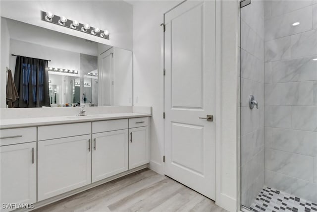 3320 41st Ave NE, Naples, FL 34120 - full bath with vanity, a tile shower, and wood finished floors