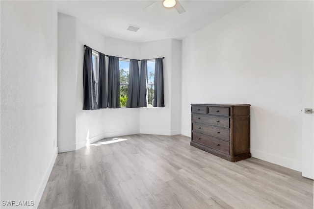 3320 41st Ave NE, Naples, FL 34120 - unfurnished bedroom with wood finished floors and a ceiling fan