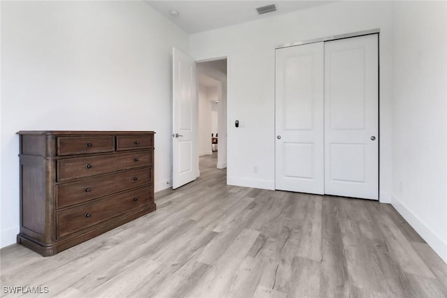 3320 41st Ave NE, Naples, FL 34120 - bedroom with light wood finished floors and a closet