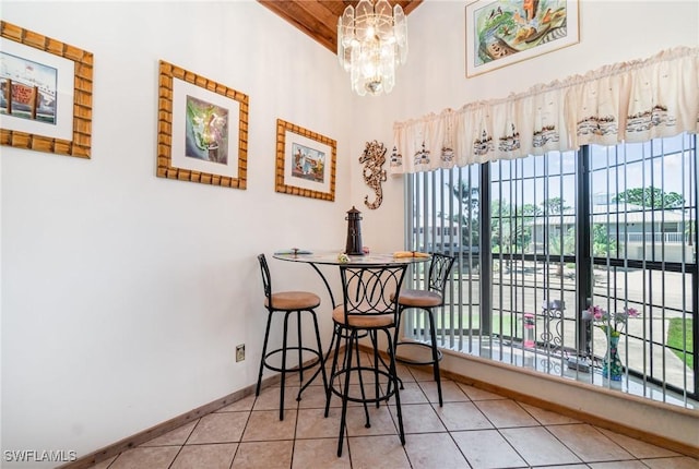 7786 Breakwater Ct, Bokeelia, FL 33922 - dining room featuring healthy amount of natural light, a wooden ceiling with exposed beams, tile patterned floors, high vaulted ceiling, and a chandelier