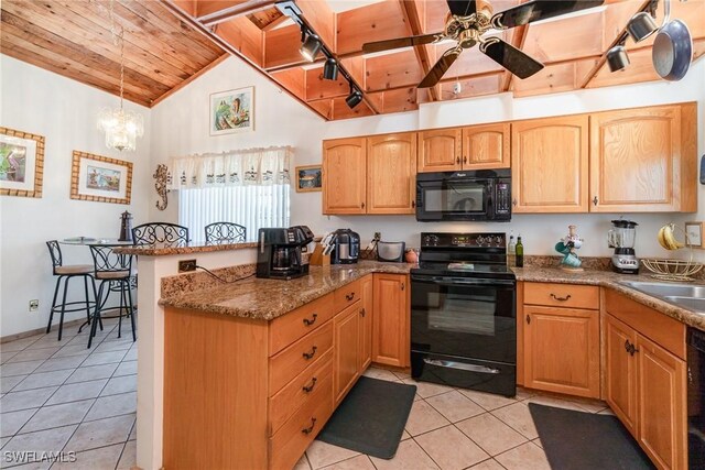 7786 Breakwater Ct, Bokeelia, FL 33922 - kitchen with black appliances, wooden ceiling, a peninsula, light tile patterned floors, and ceiling fan