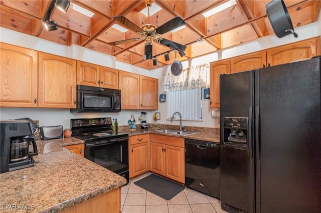 7786 Breakwater Ct, Bokeelia, FL 33922 - kitchen with black appliances, light tile patterned floors, dark stone countertops, and ceiling fan
