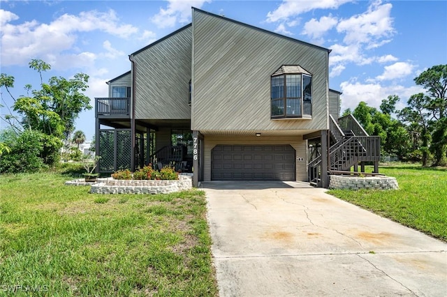 7786 Breakwater Ct, Bokeelia, FL 33922 - view of front of property featuring stairway, an attached garage, driveway, and a front lawn