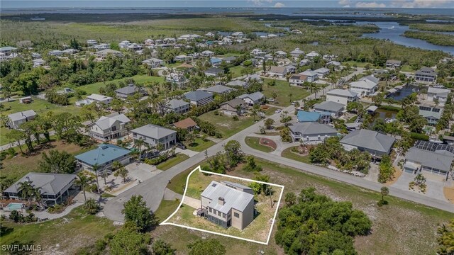 7786 Breakwater Ct, Bokeelia, FL 33922 - aerial perspective of suburban area with a nearby body of water and property boundaries highlighted