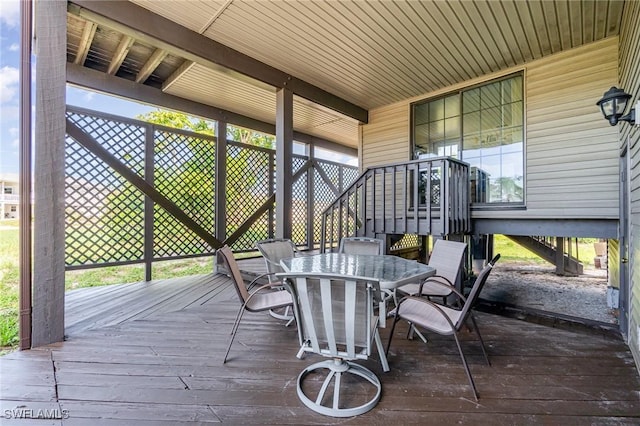 7786 Breakwater Ct, Bokeelia, FL 33922 - wooden terrace featuring outdoor dining space
