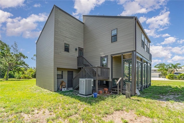 7786 Breakwater Ct, Bokeelia, FL 33922 - rear view of house with stairway and a yard