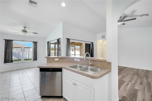 726 SW 12th St, Cape Coral, FL 33991 - kitchen featuring stainless steel dishwasher, a ceiling fan, white cabinetry, open floor plan, and light countertops