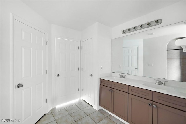 726 SW 12th St, Cape Coral, FL 33991 - full bathroom with double vanity, tile patterned flooring, and a closet