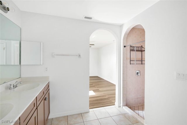 726 SW 12th St, Cape Coral, FL 33991 - bathroom featuring double vanity, tiled shower, tile patterned flooring, and a ceiling fan