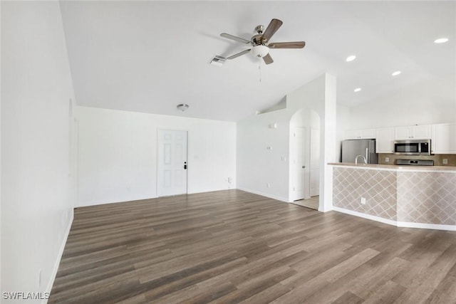 726 SW 12th St, Cape Coral, FL 33991 - unfurnished living room with ceiling fan, wood finished floors, arched walkways, high vaulted ceiling, and recessed lighting