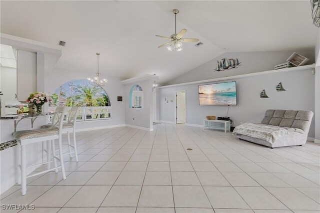 1525 SW 43rd Ter, Cape Coral, FL 33914 - living room with a ceiling fan, vaulted ceiling, a chandelier, baseboards, and light tile patterned floors