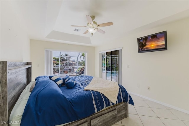 1525 SW 43rd Ter, Cape Coral, FL 33914 - bedroom with access to outside, light tile patterned flooring, baseboards, ceiling fan, and a tray ceiling