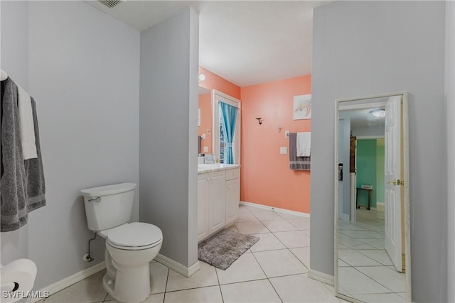 1525 SW 43rd Ter, Cape Coral, FL 33914 - bathroom with toilet, vanity, tile patterned floors, and baseboards