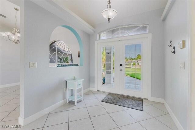 1525 SW 43rd Ter, Cape Coral, FL 33914 - tiled entrance foyer featuring healthy amount of natural light, a chandelier, french doors, and baseboards
